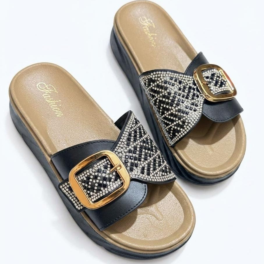 Pair of embellished sandals with gold buckles on a white background